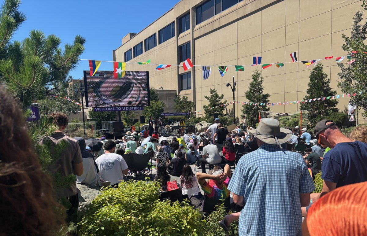 After: A turf pitch, a giant LED screen, a performance stage, seating, and an outdoor movie setup, with the crowd spilling into the closed street. 