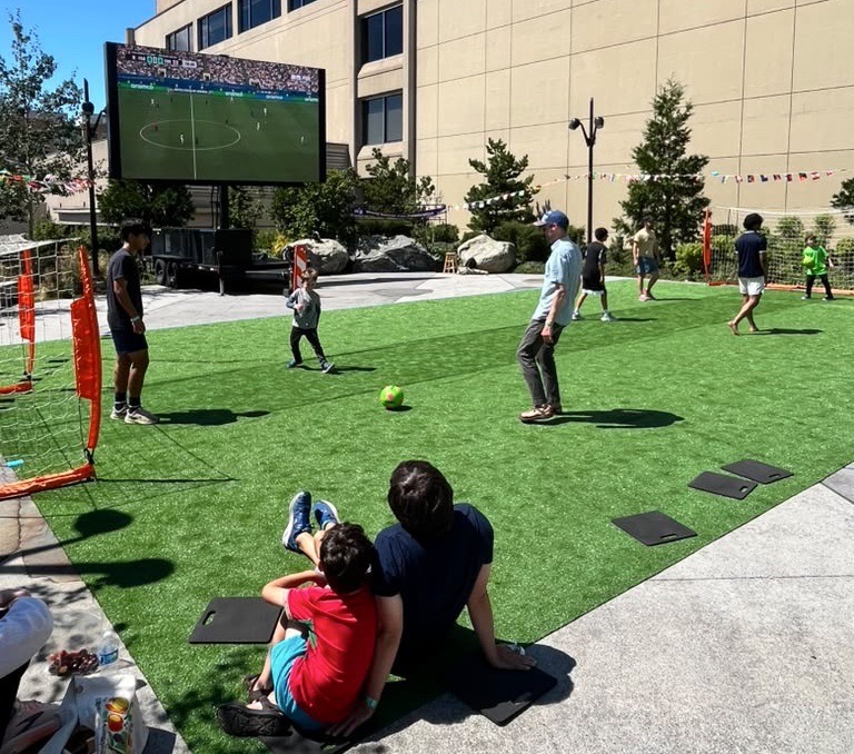 Kids and adults playing on the soccer pitch. Kids and adults playing on the soccer pitch.